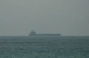 Escalation in the Strait of Hormuz: U.S.-Contracted Vessel Carrying American Personnel Struck in Iranian Drone and Missile Attack